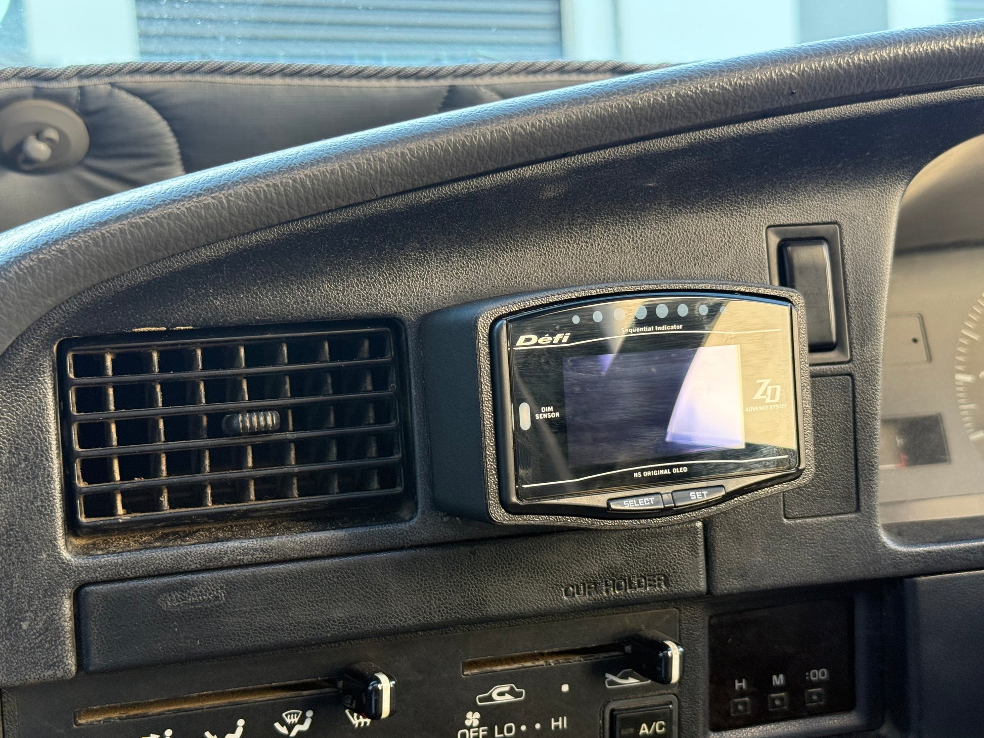 Car dashboard with a Defi racing computer display