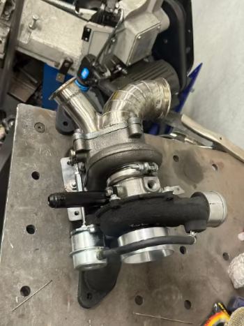 Turbocharger on a metal surface with tools in the background