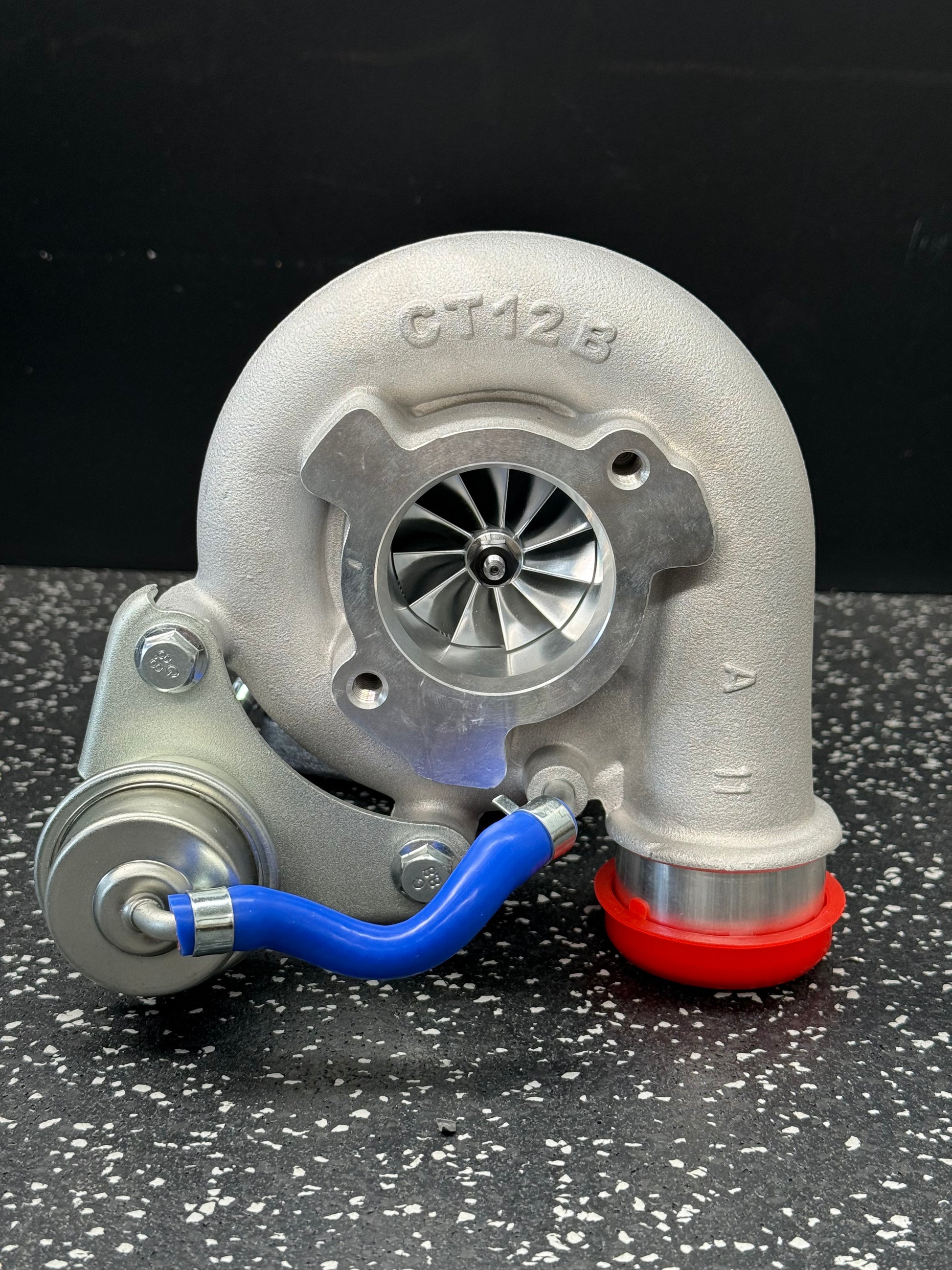 Turbocharger on a black and white speckled surface